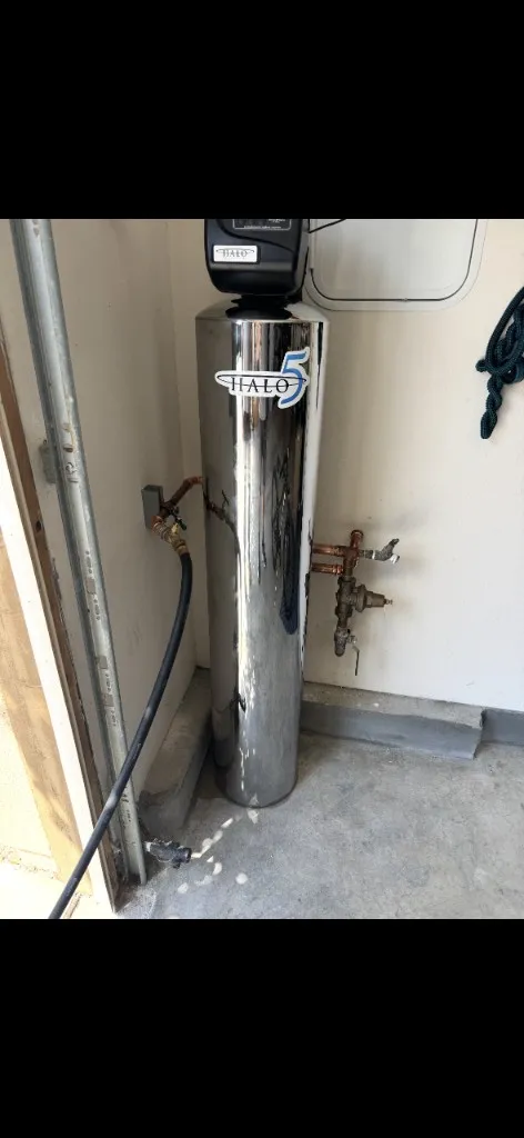 HALO 5 whole-house water filtration tank installed in a garage with copper inlet and outlet piping